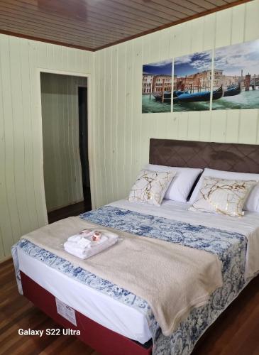 Nova VenezaInteira casa A Cammino di Venezia的卧室内的一张床铺,墙上挂着一幅画