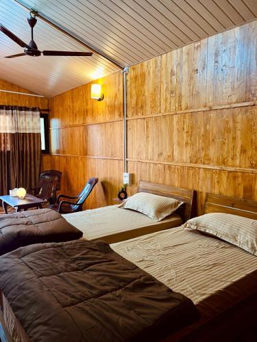 波戈马洛Stay In Woods的木墙客房的两张床