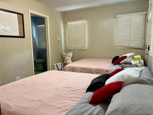芝加哥Couture Themed 3 Bedroom in Prime Spot with Patio, Parking, Fireplace, Pets Welcome的一间卧室配有两张带红白色枕头的床