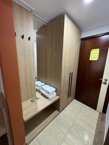 波格拉德茨莱尼达斯酒店的浴室设有木制橱柜和折叠毛巾