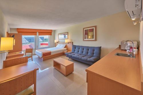 马萨特兰City Express by Marriott Mazatlan的带沙发的客厅和带沙发的客厅。