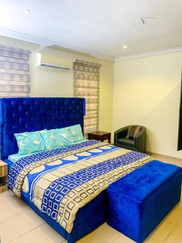 拉各斯28B (3/2B)的一间卧室配有蓝色的床和蓝色的软垫床头板