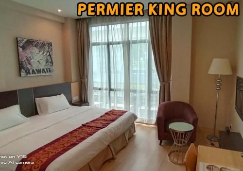 马六甲Ideals Hotel Melaka的一间卧室设有一张床和一个大窗户