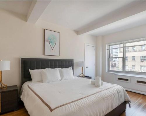 纽约Lovely 4 BR in NYC!的一间卧室设有一张大床和一个窗户。