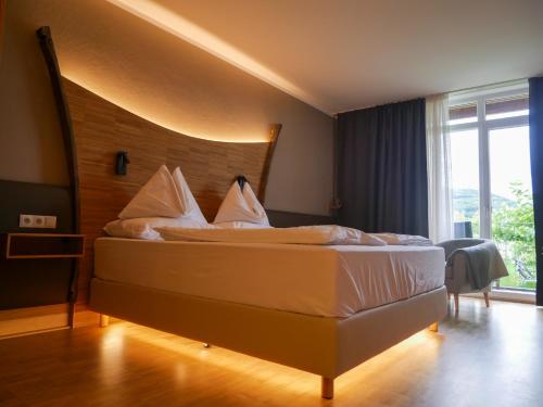 弗思Weinresidenz Sonnleitner - ADULTS ONLY的一间卧室配有一张大床和木制床头板