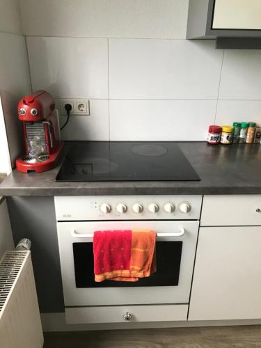 科隆FanHostel European Championship 24 Cologne City Center的厨房配有炉灶和烤箱上的红色毛巾