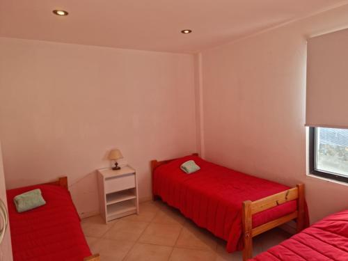 里奥格兰德Departamento de 1 Dormitorio con Sala Estar的一间卧室设有两张床和窗户。