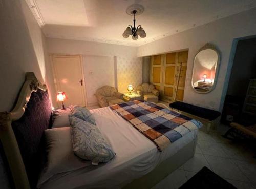 开罗Room for transit near airport的一间卧室配有一张大床和一张 ⁇ 子毯子