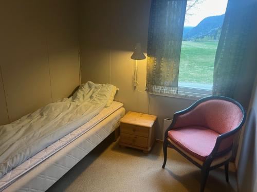 ByglandReiårsfossen Hostel & Camping的卧室配有床、椅子和窗户。