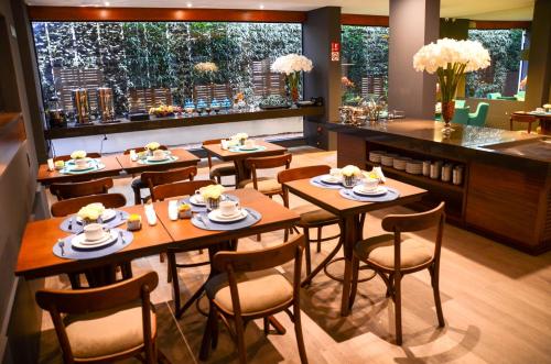 格拉玛多赛尔卡诺酒店的餐厅设有木桌、椅子和柜台