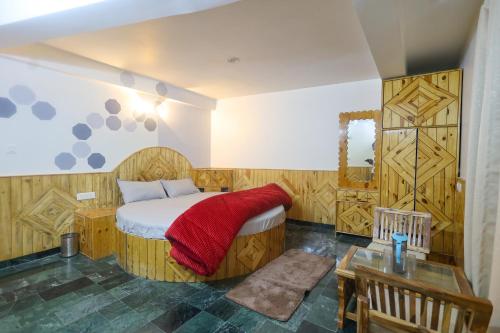 马拉里Luvya Retreats Hotel的一间卧室配有一张床铺,床上铺有红色毯子