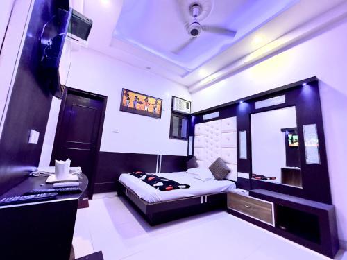 新德里PEACE POINT FAMILY HOTEL By AKJ的一间卧室配有一张床和一张书桌
