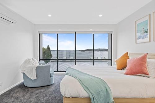 华纳海湾Lakeview Luxury - Work from home spaces的一间卧室设有一张大床和一个大窗户