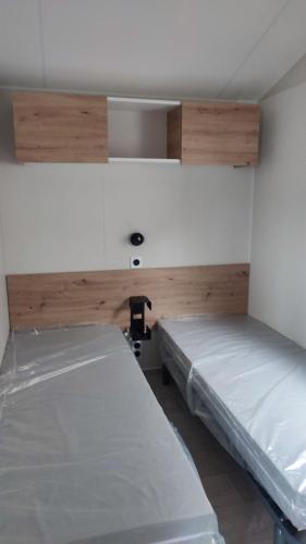 AmbonTiny house camping Ambon的一间客房内配有两张床的房间