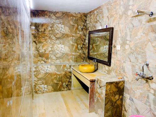 斋沙默尔Serendipity desert Camp in Thar Desert的石质浴室设有水槽和镜子