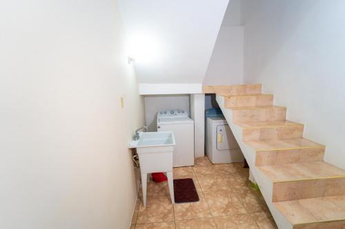 拉纳韦贝Villa Suites in Runaway Bay的一个小浴室,设有楼梯和水槽