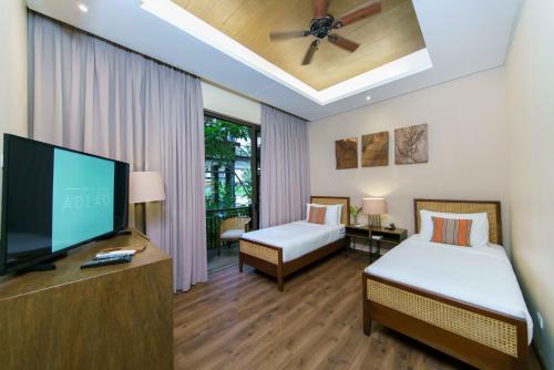 爱妮岛巴莱阿德劳酒店的酒店客房设有两张床和一台平面电视。