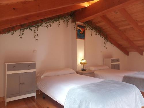 ReocínCasa Rural Villapresente的配有木天花板的客房设有两张床。