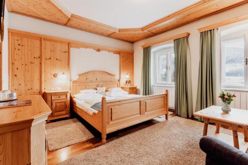格绍兰德豪斯科勒酒店的一间卧室设有一张大床和两个窗户。