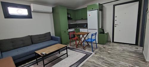 Karaköprü KöyüYOUR HOUSE Apart Otel的带沙发和桌子的客厅以及厨房。