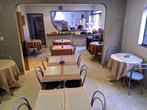 圣保罗Hotel Makuxis - Brigadeiro的一间带桌椅的餐厅和一间厨房