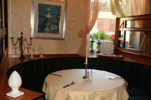 Oberstenfeld欧莱可酒店的用餐室配有带蜡烛的桌子