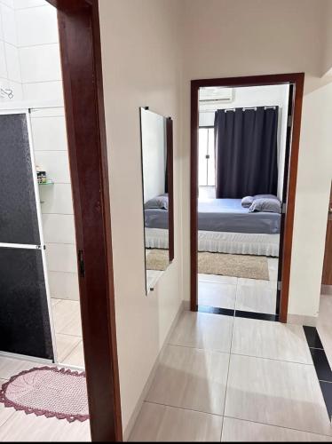 锡诺普Casa privada em Sinop的带镜子和床的房间以及一间卧室