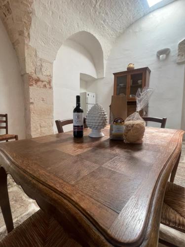 卡斯特拉纳格罗泰masseria Don Bonifacio的一张木桌,上面放有两瓶葡萄酒