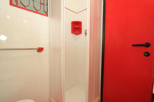 利多波波萨Eco del Mare Apartments的浴室里设有红色门淋浴