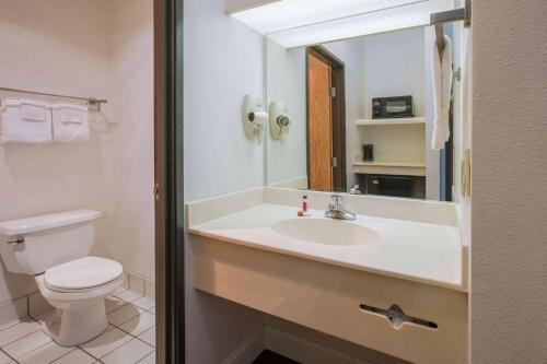 加兰加兰北达拉斯速8酒店的一间带水槽、卫生间和镜子的浴室