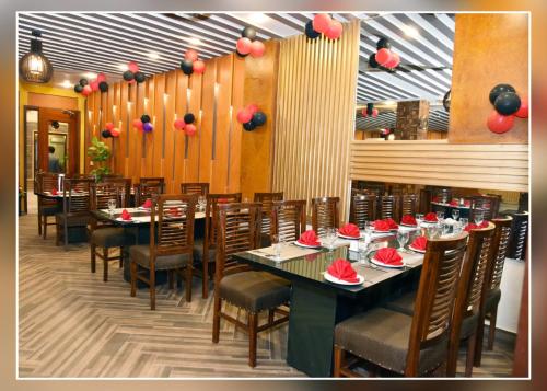 卡拉尔哥特MZ Hotel and Restaurant Sukkur的一间拥有桌椅和红色装饰的用餐室