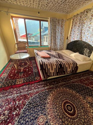 帕哈尔加姆Pine Brooke Pahalgam的一间卧室设有床、窗户和地毯。