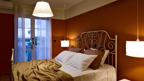 马尔马里Kamara Apartments Marmari的一间卧室配有一张床和两个灯