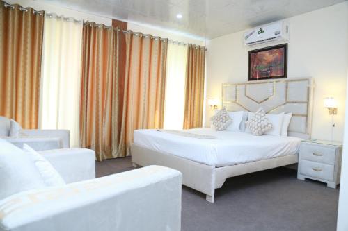 拉合尔Hotel palm east lahore的酒店客房,配有两张床和两把椅子