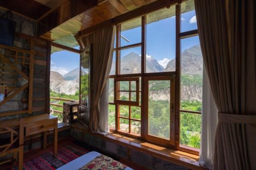 Karimabad HunzaOff-grid Home Hunza的客房设有窗户,享有山景。