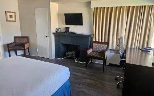 温哥华2400汽车旅馆的酒店客房配有一张床和一个壁炉。