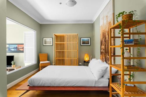 悉尼'Laube 105' Modern Inner-city Sanctuary with Balcony的一间卧室设有一张床和一个书架