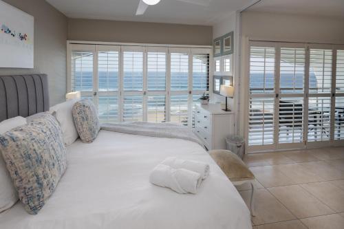 德班504 Bermudas - by Stay in Umhlanga的卧室设有白色床,享有海景