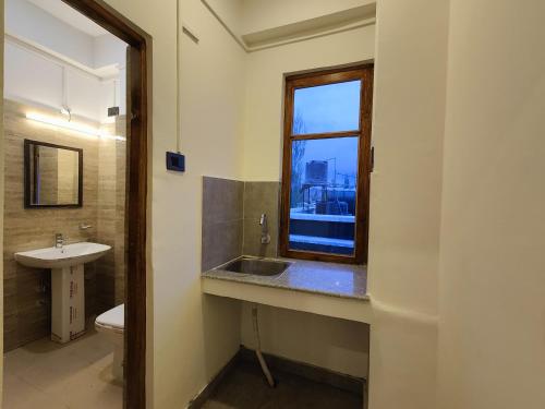 列城Zanu Residency的一间带水槽和窗户的浴室