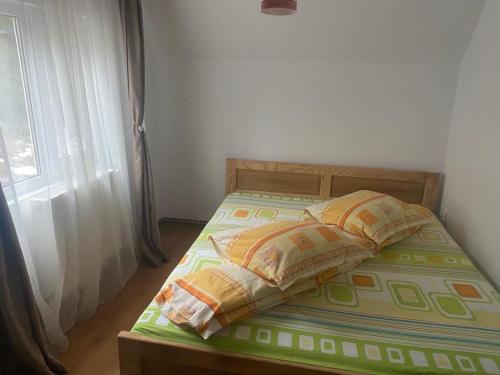 兰卡Lupul Dacic的一间卧室配有带两个枕头的床和窗户