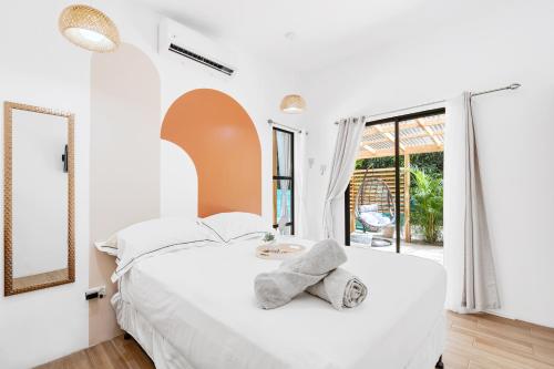 马塔帕洛Casa Sunshine y Palmeras的白色卧室配有一张带镜子的大床