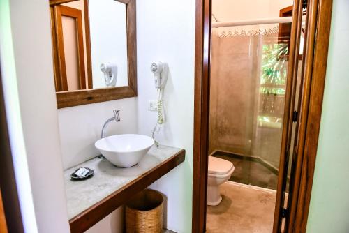 伊利亚贝拉Suítes Forte Rocha的一间带水槽、卫生间和镜子的浴室
