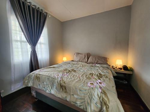 SiborongborongPorlak Hebron Family Homestay的一间卧室设有一张床和一个窗口
