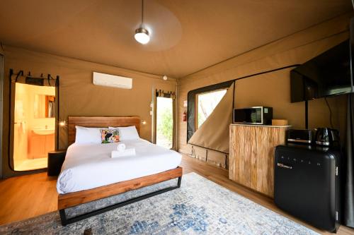 BelairBelair National Park Holiday Park的一间卧室配有一张床和一台电视。
