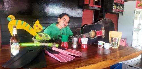 Muang KhôngThe Smiling Lao的坐在桌子上的带吉他的妇女