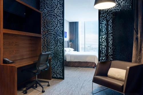 墨西哥城墨西哥城圣达菲希尔顿酒店的酒店客房配有一张床、一张桌子和一把椅子。