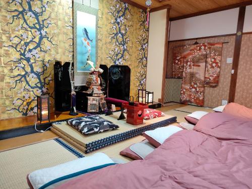 南关町Morita-ya Japanese style inn KingyoーVacation STAY 62437的一间设有三张床的客房和一幅画作的墙壁