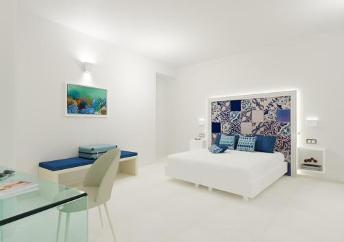 阿马尔菲Amalfi Suite Boutique Hotel的白色的客厅配有床和桌子