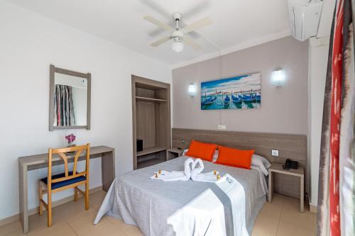 埃尔阿雷纳尔Hotel Costa Mediterraneo的酒店客房设有两张床和一张桌子。