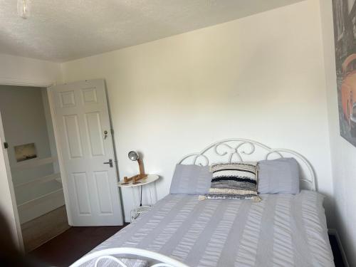 惠茨特布尔The Heath Retreat的卧室内的白色床和蓝色枕头